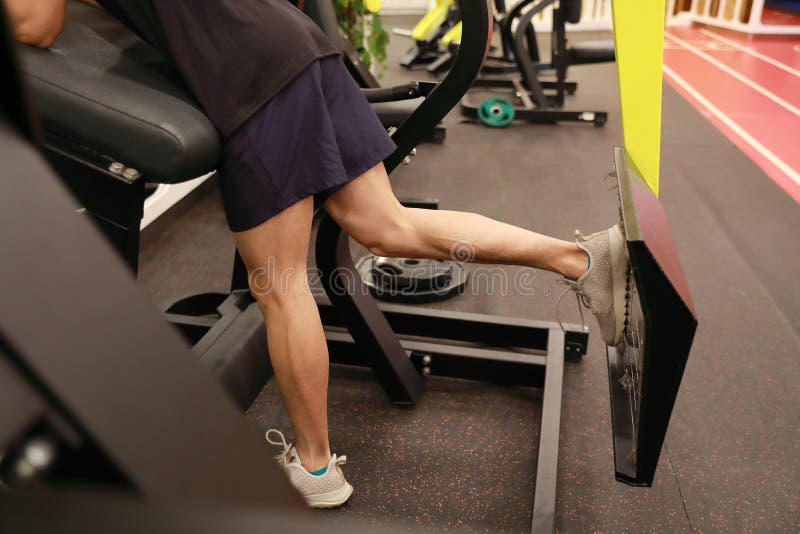 Asian chinese man in gym ,Fitness sport man Training of leg strength in the gym. Young fitness man Training of leg strength in the gym , Weight Training At stock images Asian chinese man in gym ,Fitness sport man Training of leg strength in the gym. Young fitness man Training of leg strength in the gym , Weight Training At stock images